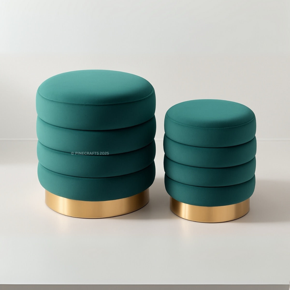 Two teal stools with gold bases on a white background