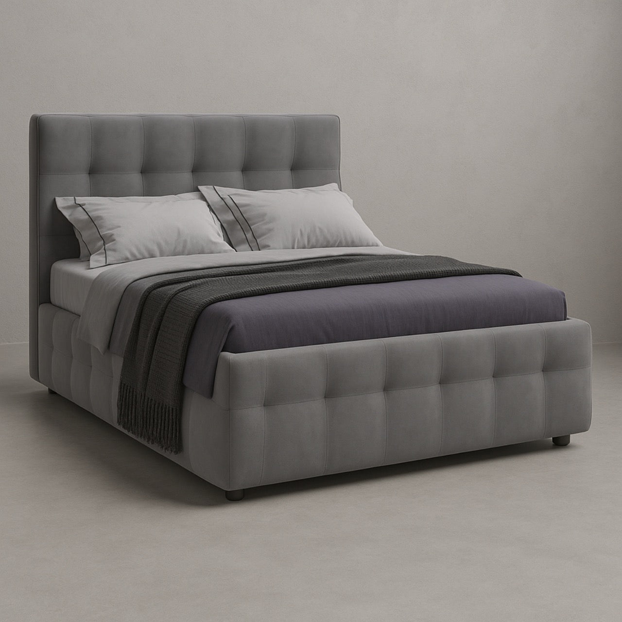 Gray upholstered bed with matching bedding in a neutral setting