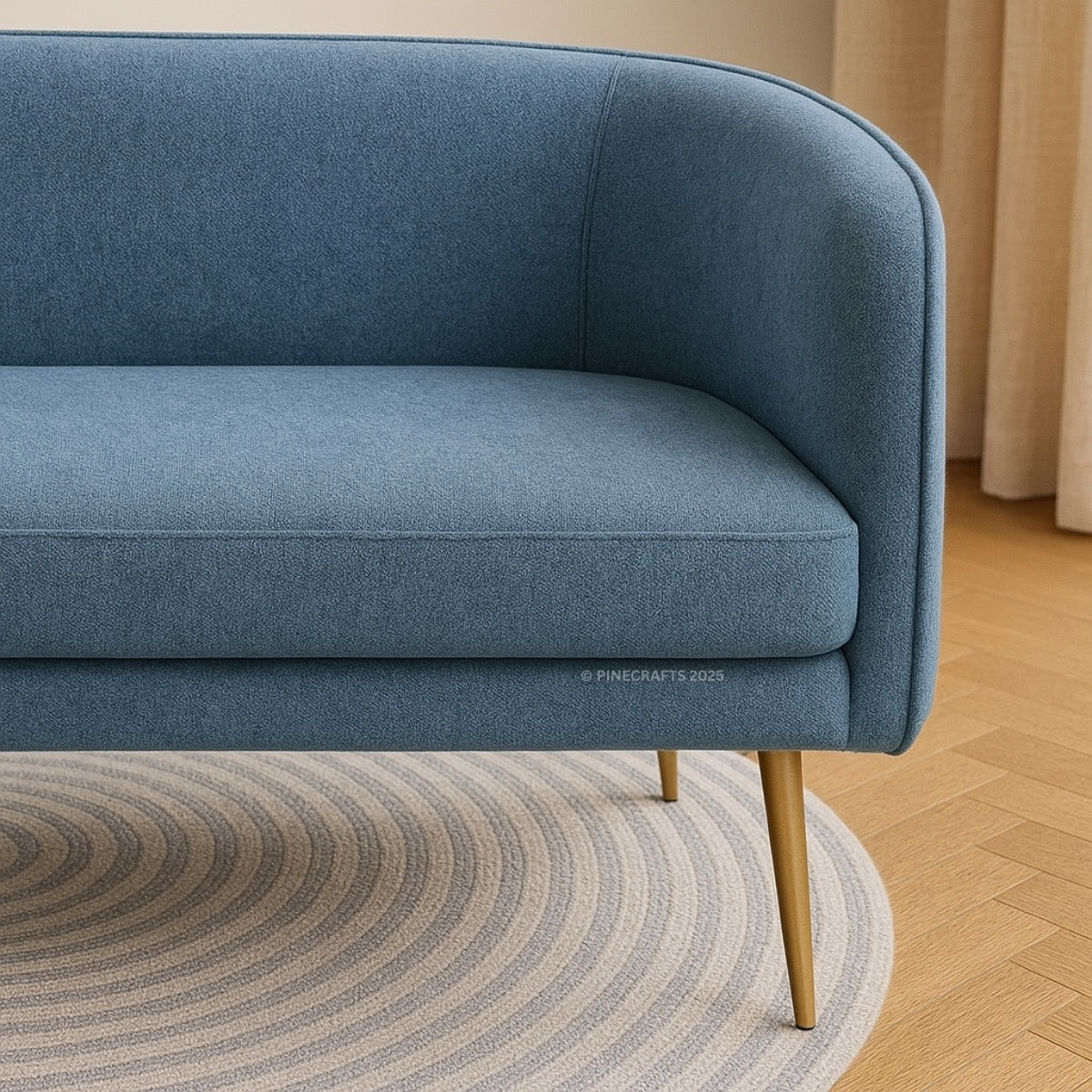 Blue sofa with wooden legs on a wooden floor with a round rug