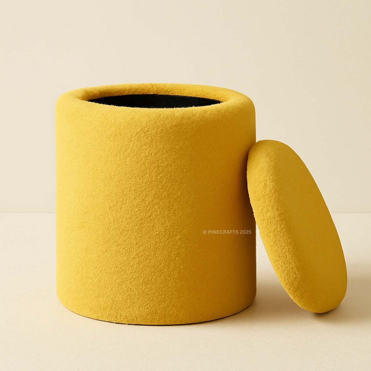 Yellow cylindrical container with a lid on a beige background