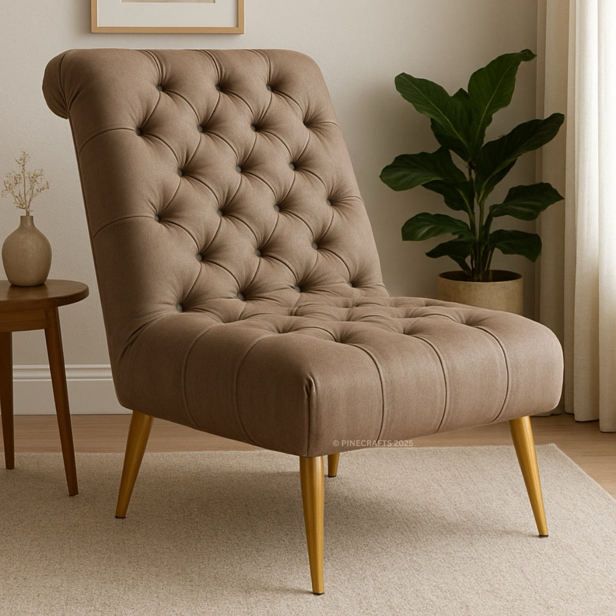Brown tufted chair with gold legs in a room setting with a plant and small table.
