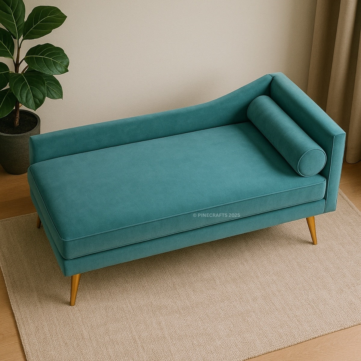 Teal sofa with gold legs on a beige rug, plant to the left.