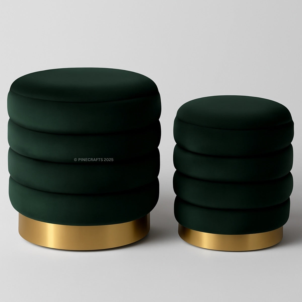 Two dark green stools with gold bases on a light gray background