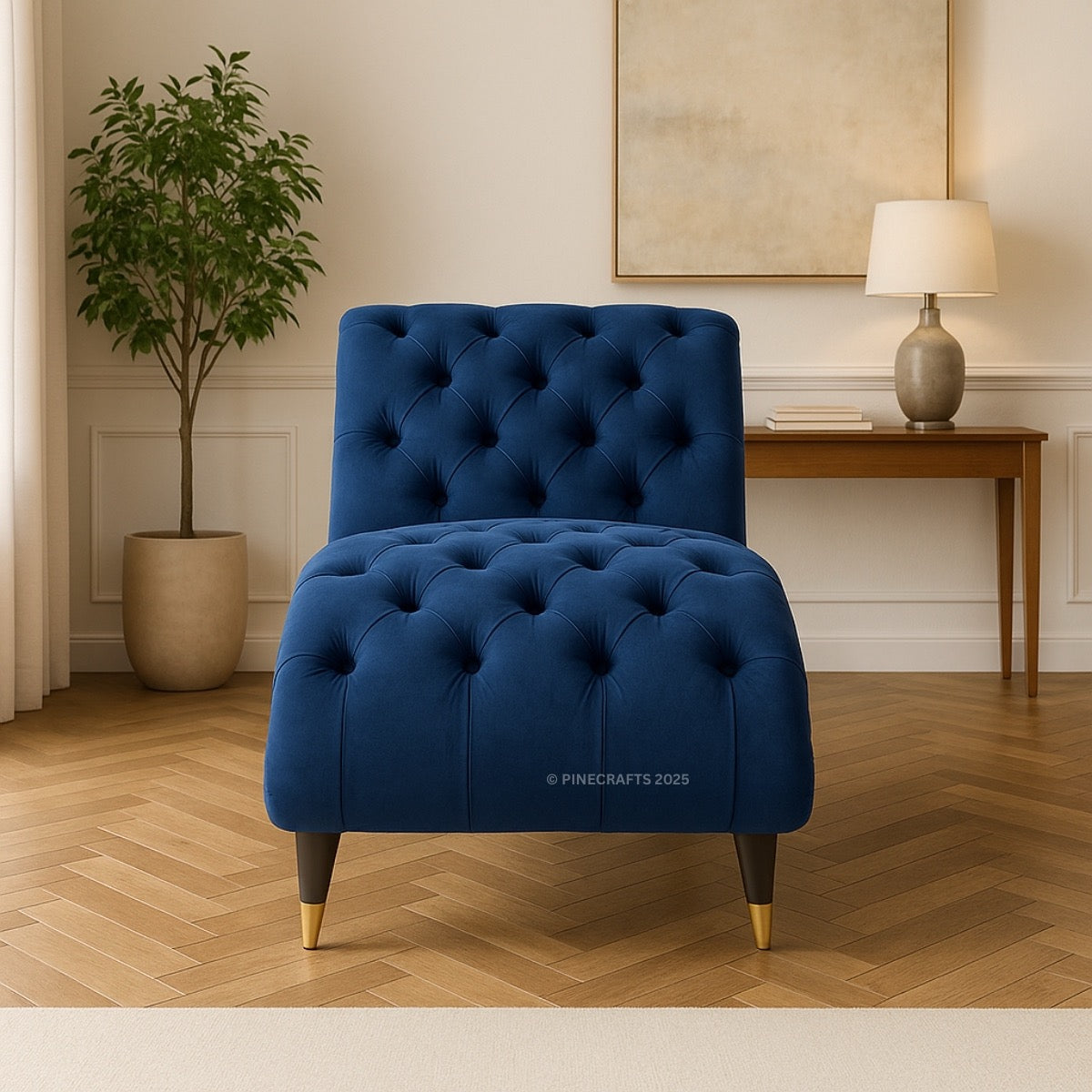 Blue tufted chair in a room with a plant and table.