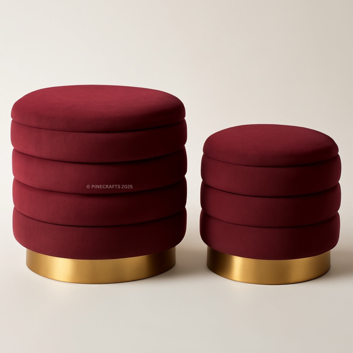 Two red stools with gold bases on a beige background