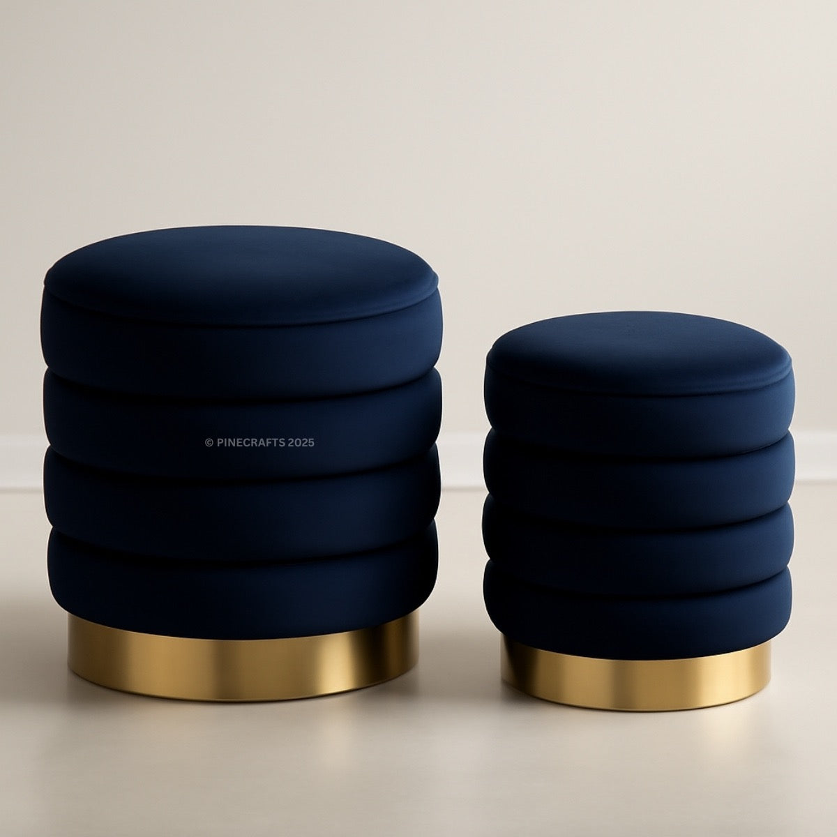 Two navy blue stools with gold bases on a light background