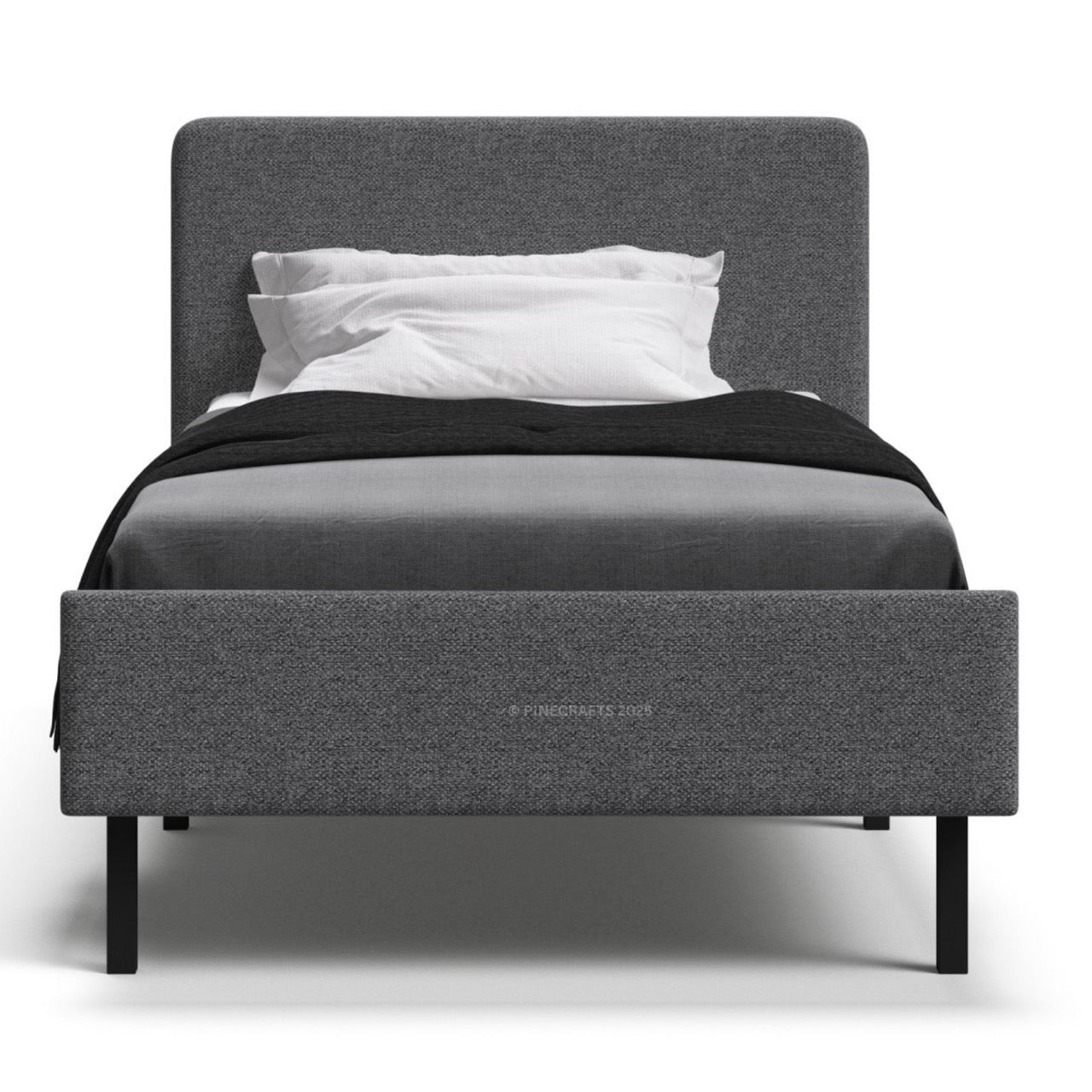 Gray upholstered bed with black bedding and white pillows on a white background