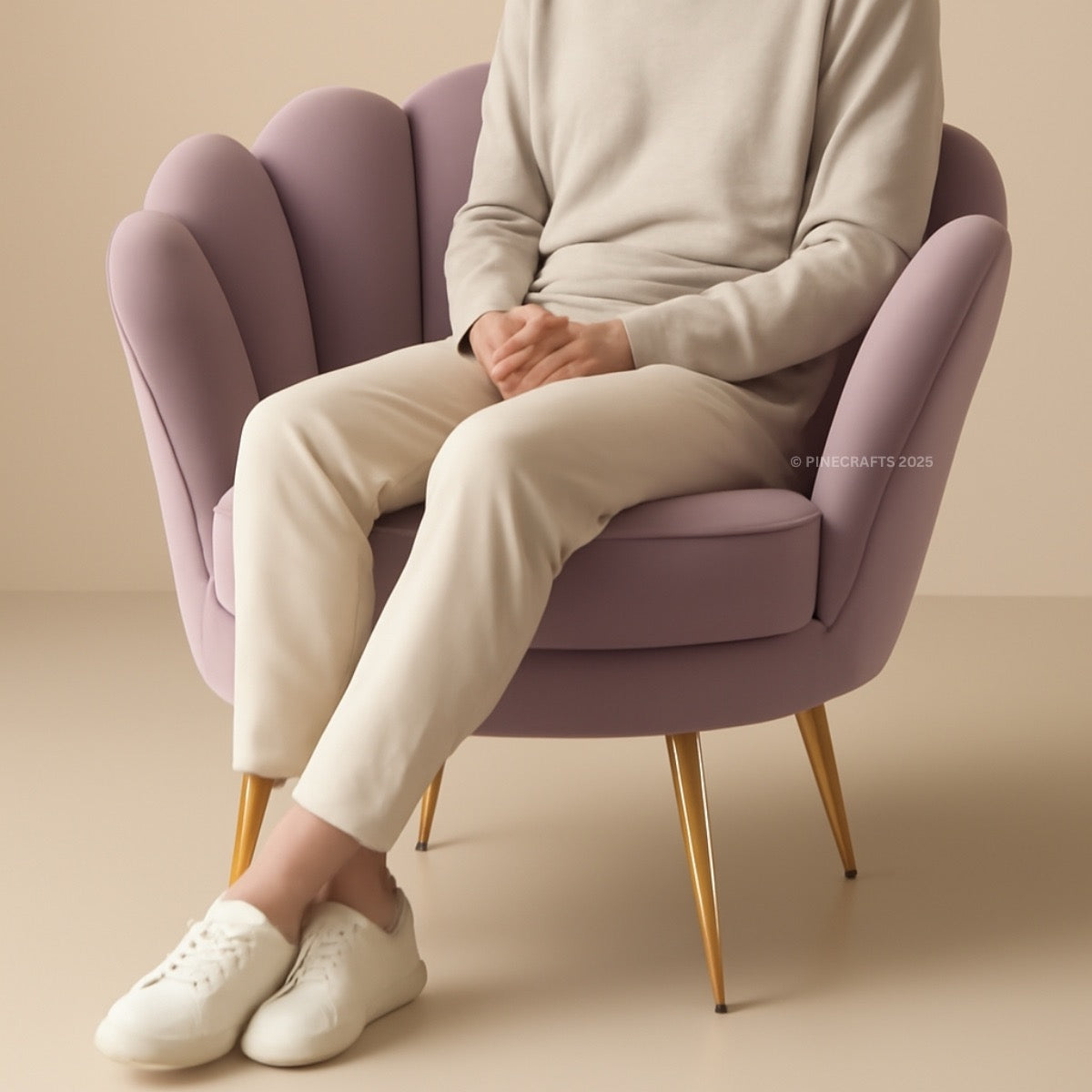 Person sitting on a purple chair wearing a light gray sweater, beige pants, and white shoes.