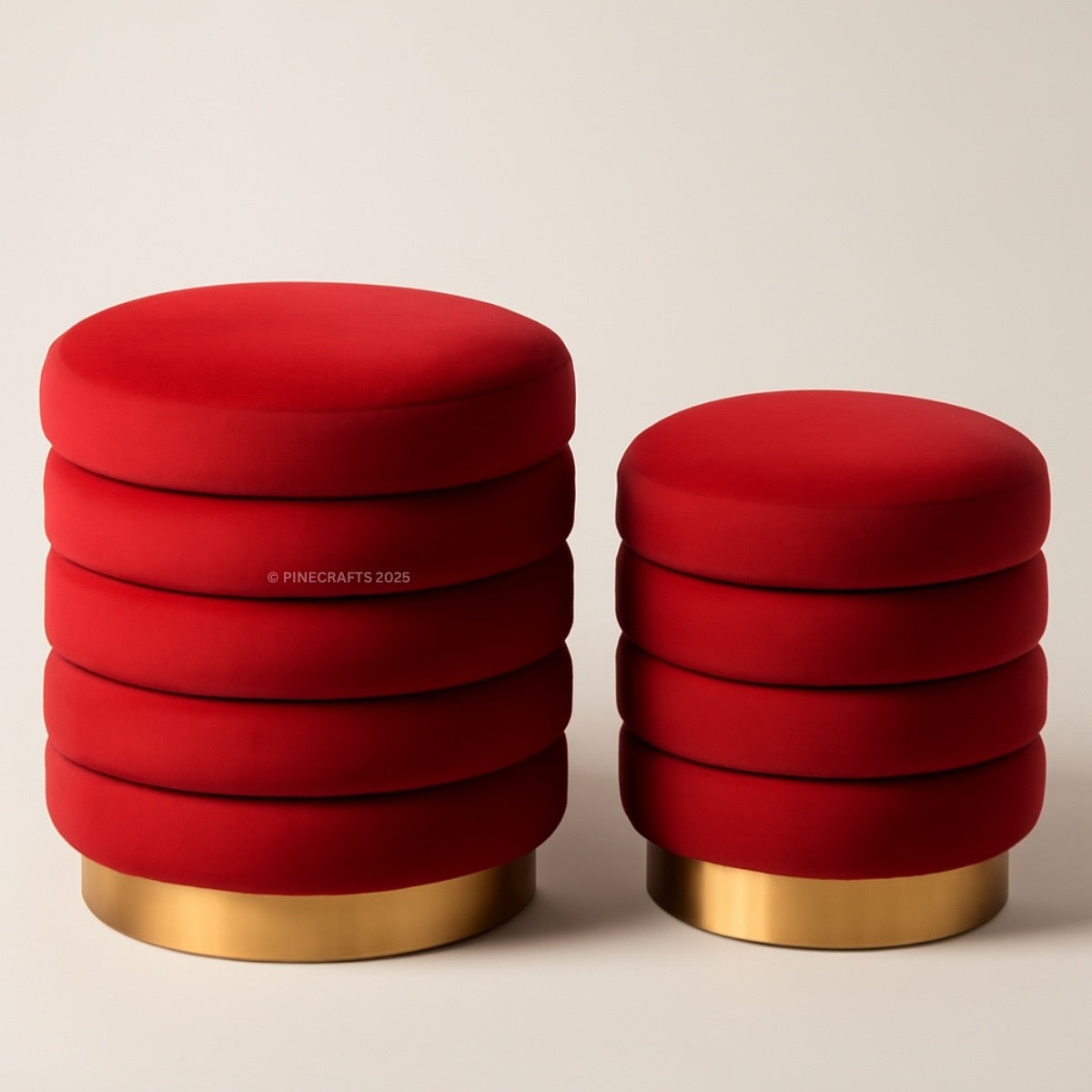 Two red stools with gold bases on a beige background