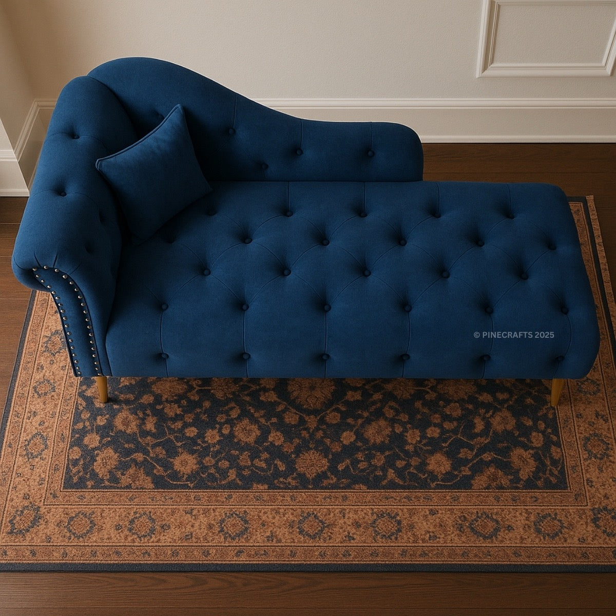 Blue tufted chaise lounge on a patterned rug with 'Pinecrafts' branding.