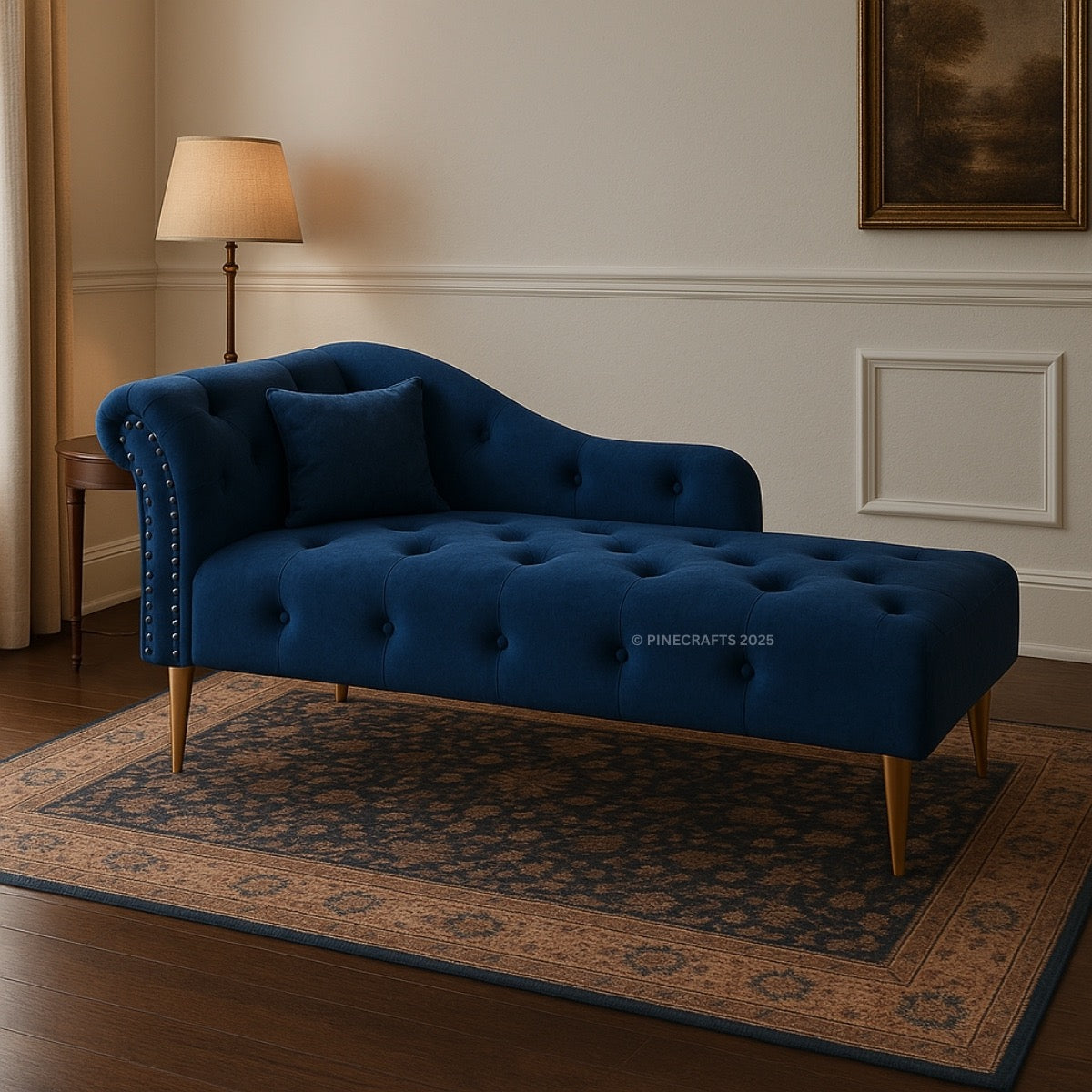 Blue velvet chaise lounge in a room with a lamp and framed picture.