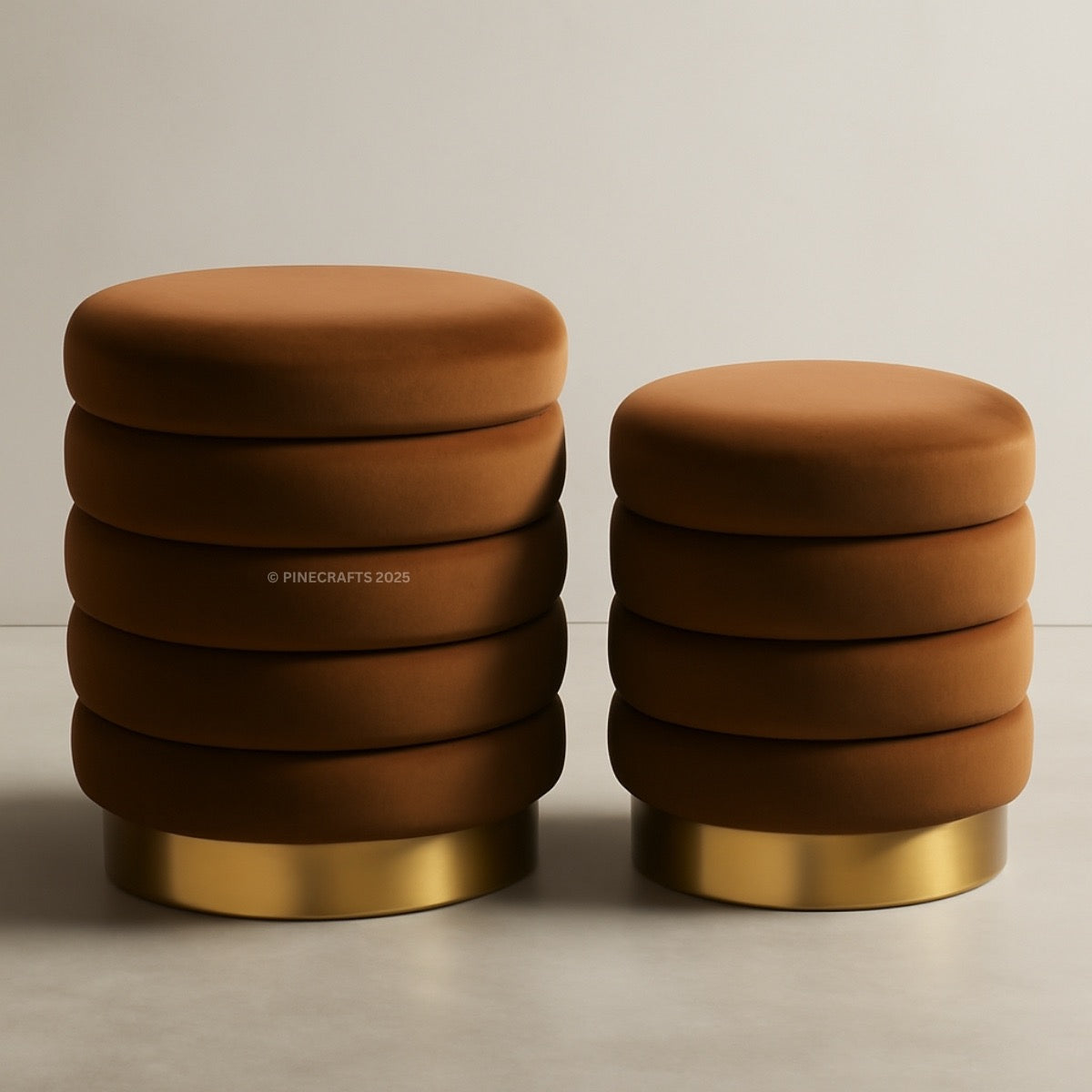 Two brown ottomans with gold bases on a beige background