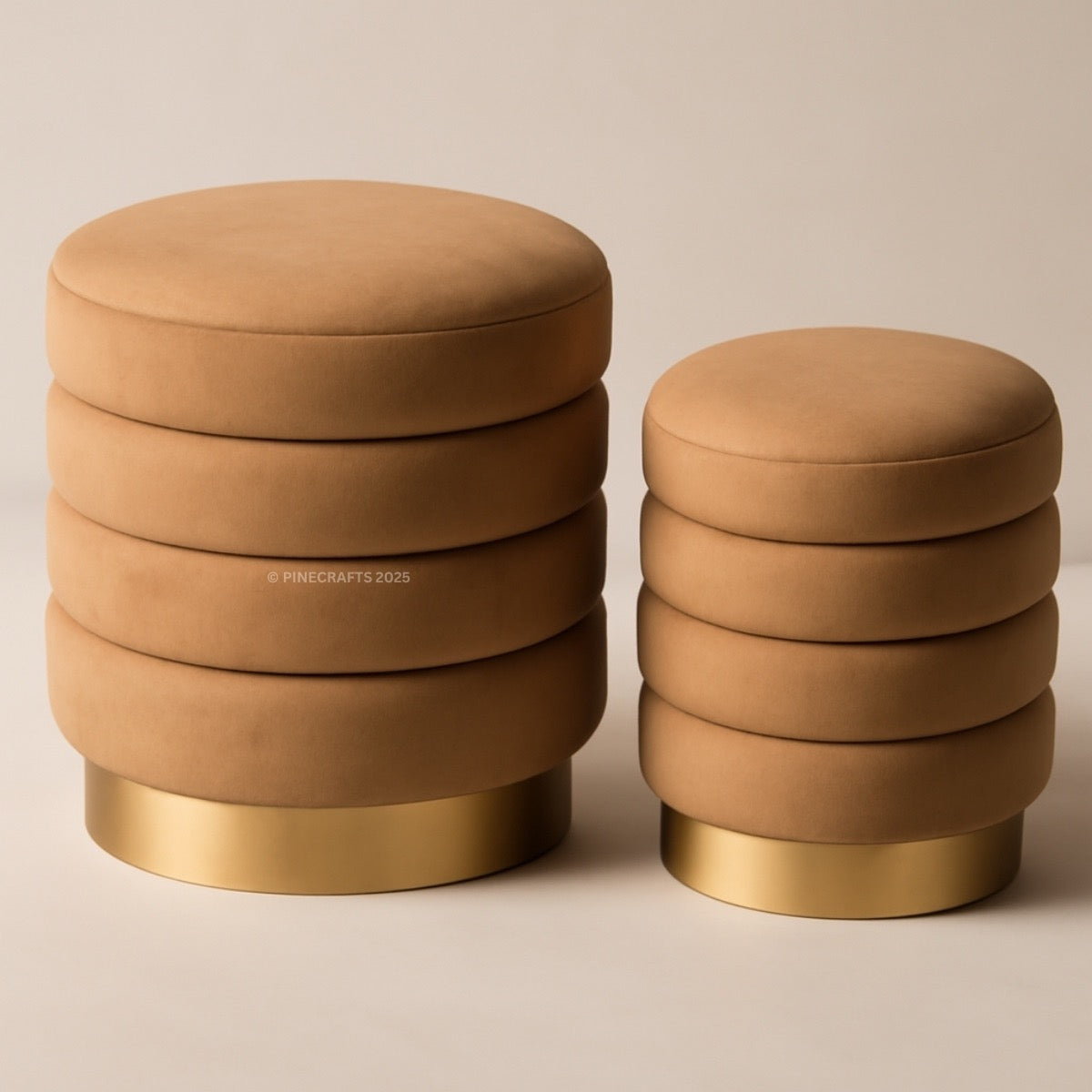 Two brown ottomans with gold bases on a beige background