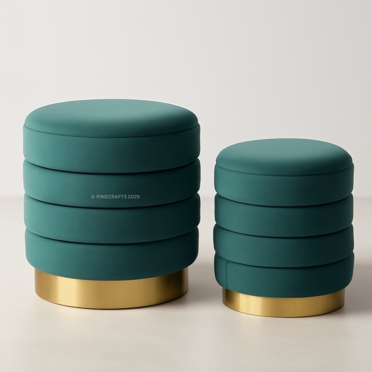 Two teal ottomans with gold bases on a light background