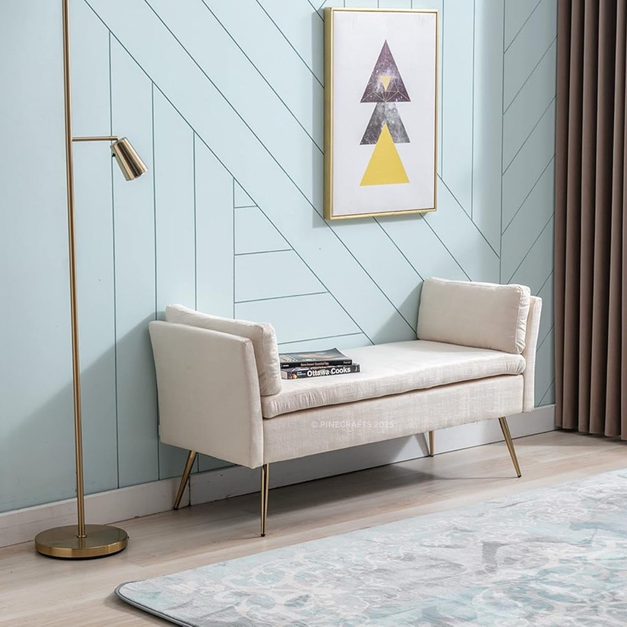 Beige bench against a light blue wall with a gold floor lamp and abstract art.