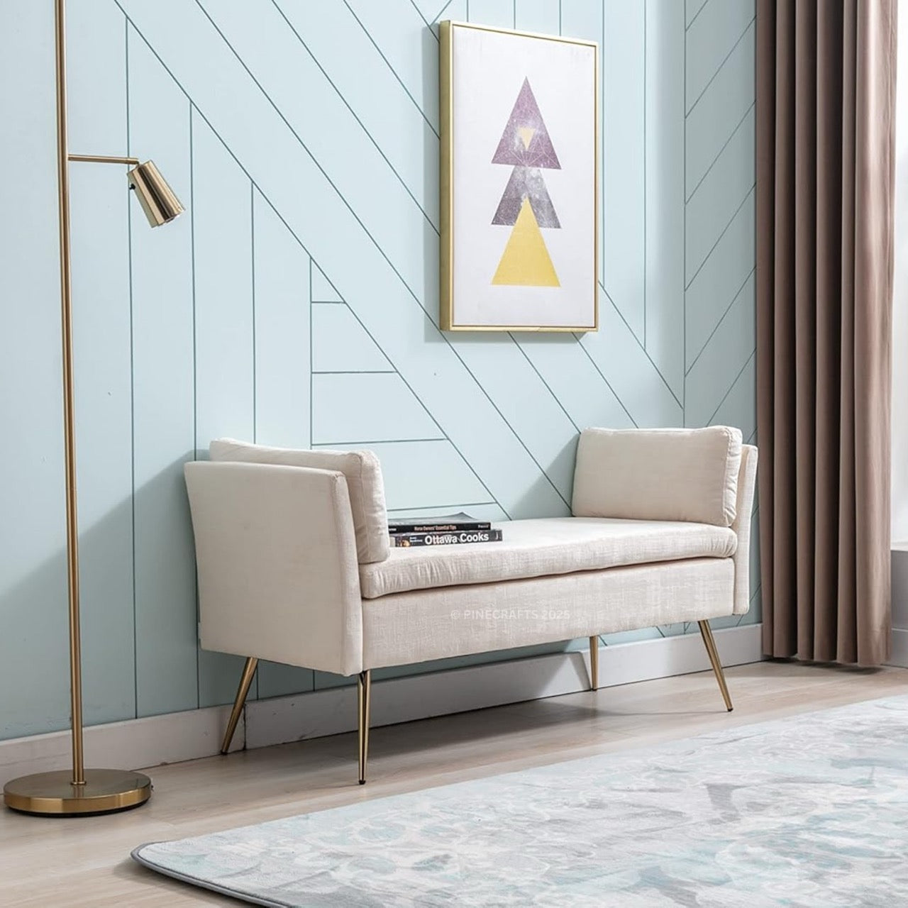 Beige bench against a light blue paneled wall with a gold floor lamp and framed abstract art.