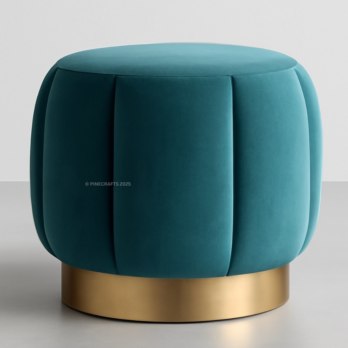 Teal ottoman with a gold base on a light gray background