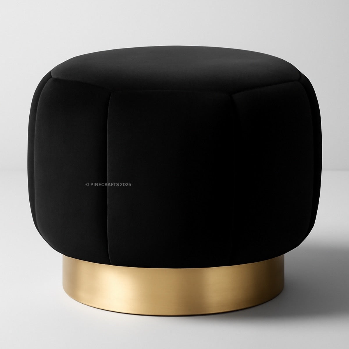 Black cushioned stool with a gold base on a light gray background