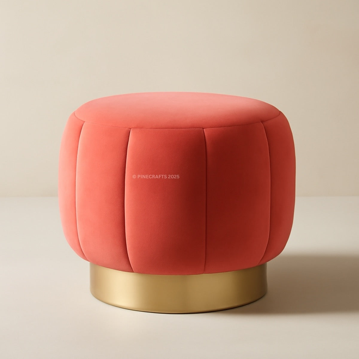 Red cushioned stool with gold base on a beige background