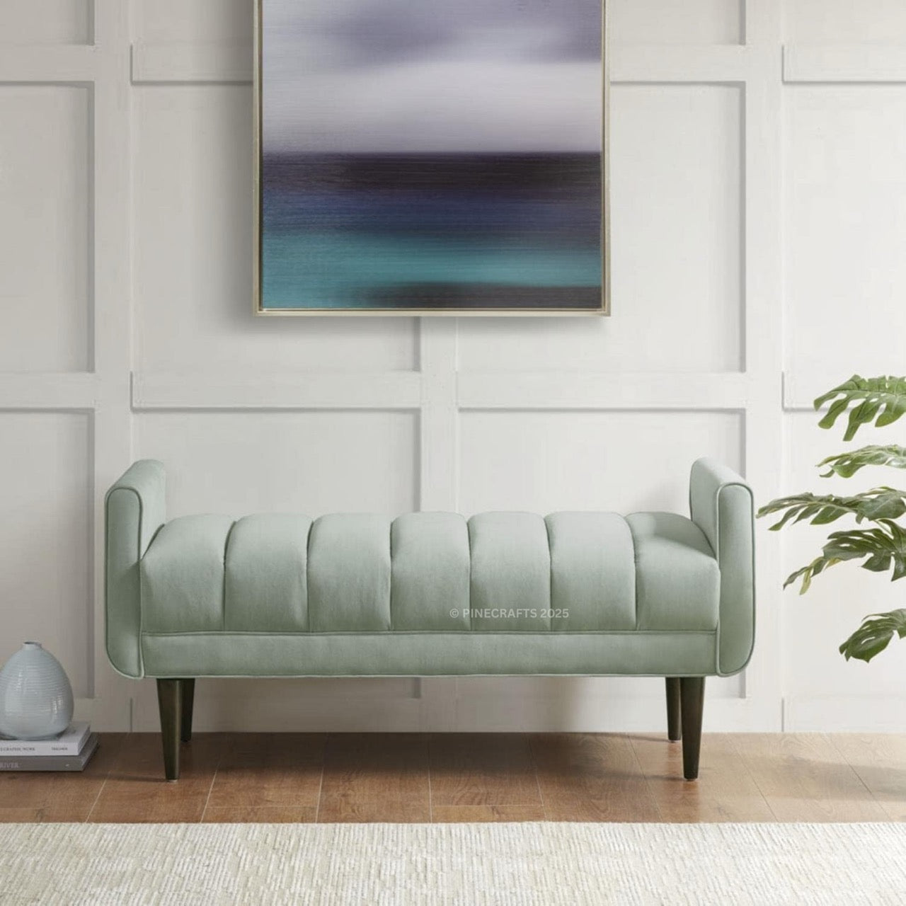 Green bench in a room with a abstract painting on the wall