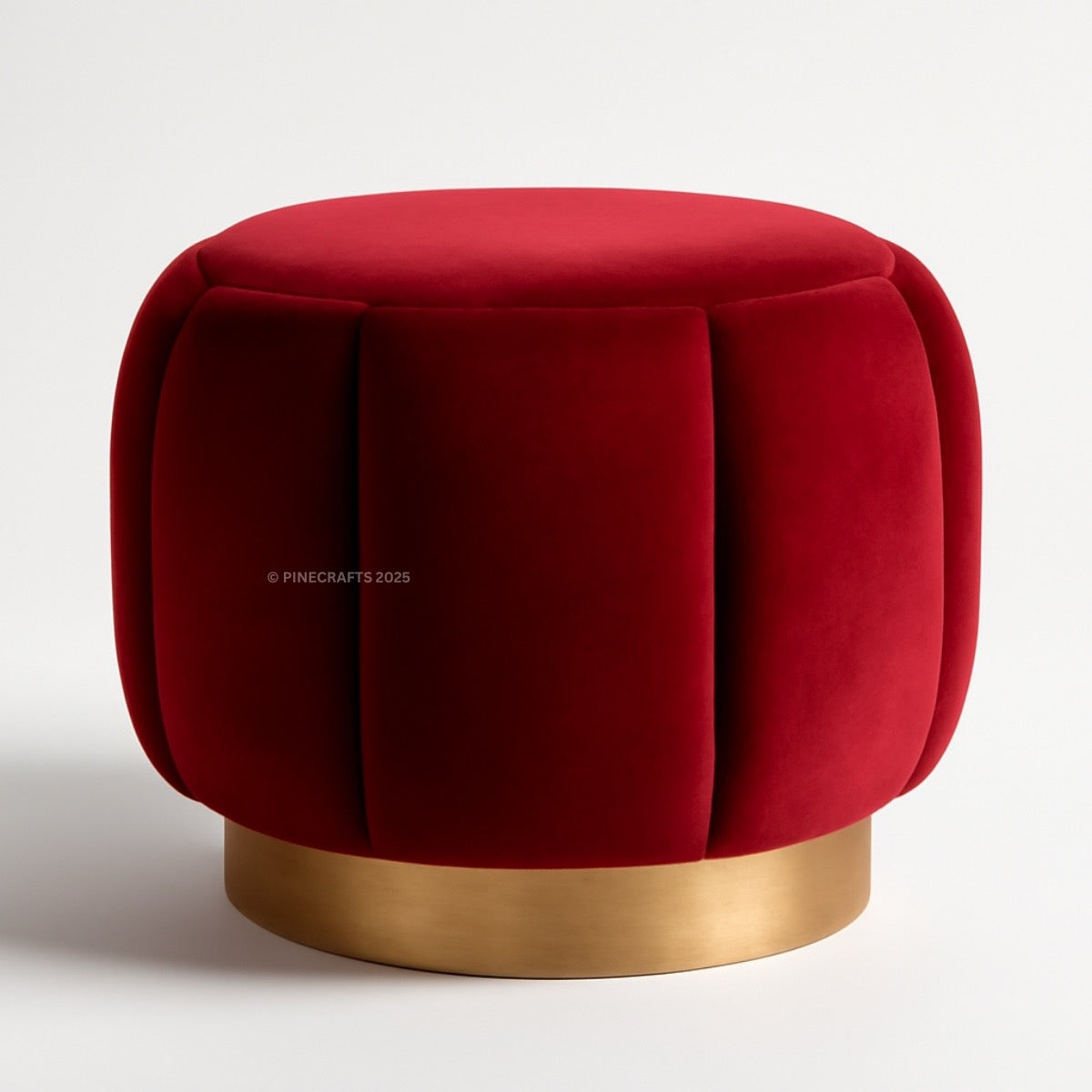 Red velvet ottoman with a gold base on a white background