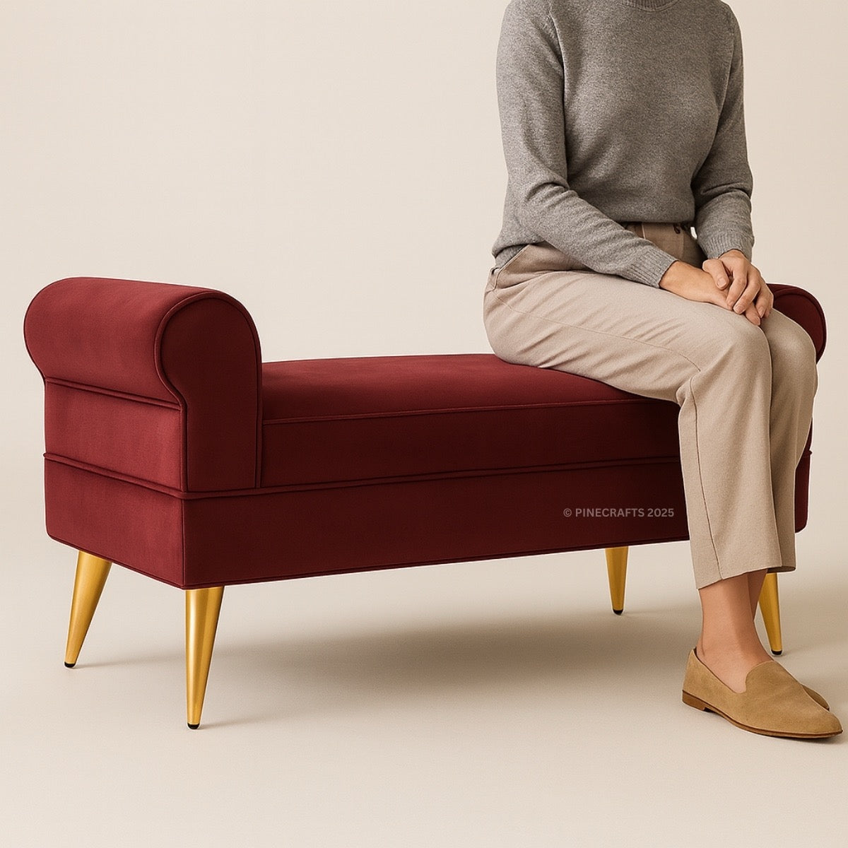 Person sitting on a red bench with gold legs against a beige background