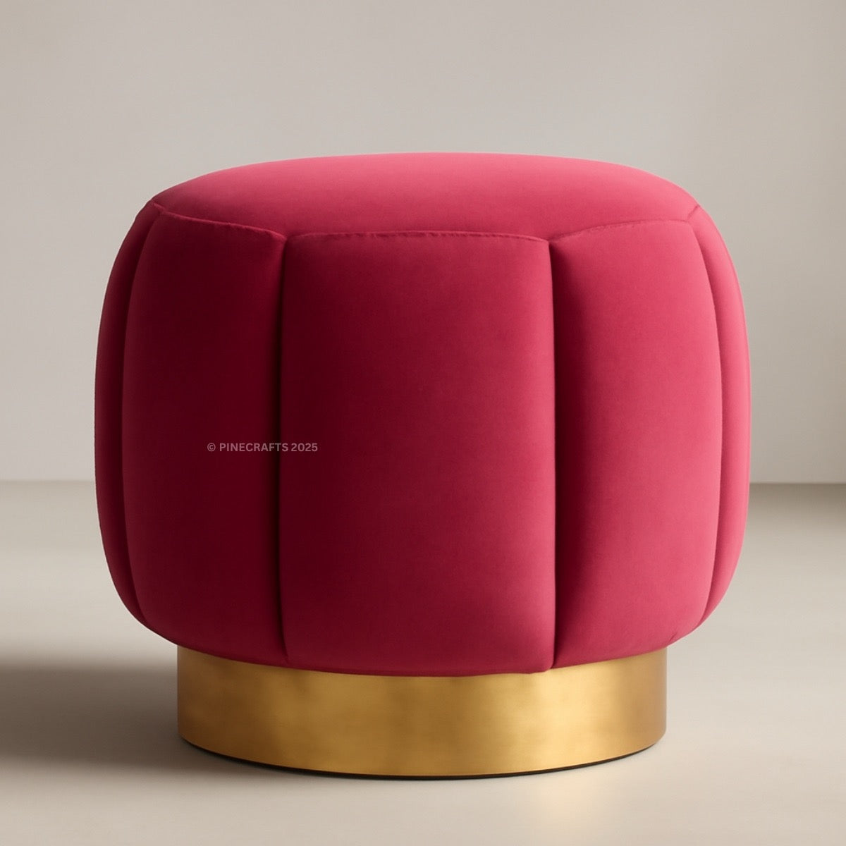 Red cushioned stool with a gold base on a neutral background