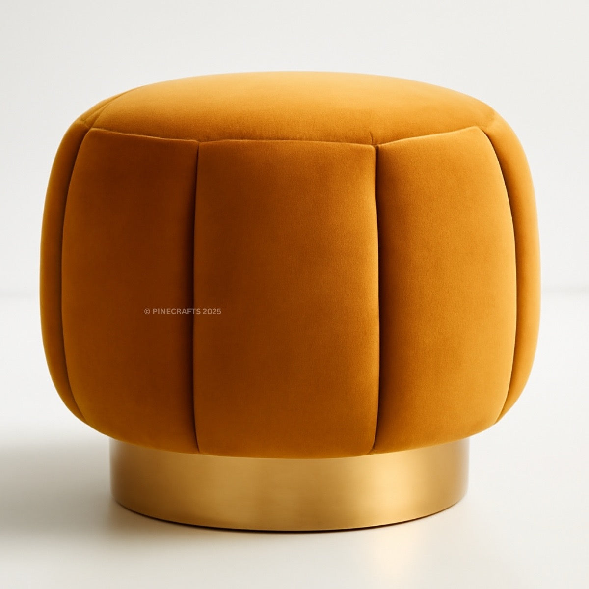 Mustard yellow ottoman with a gold base on a white background