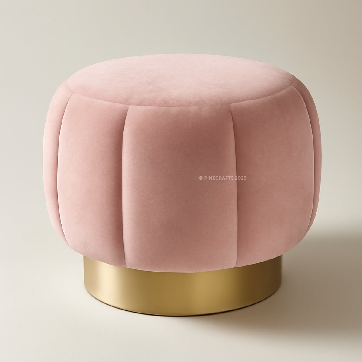 Pink velvet ottoman with a gold base on a beige background