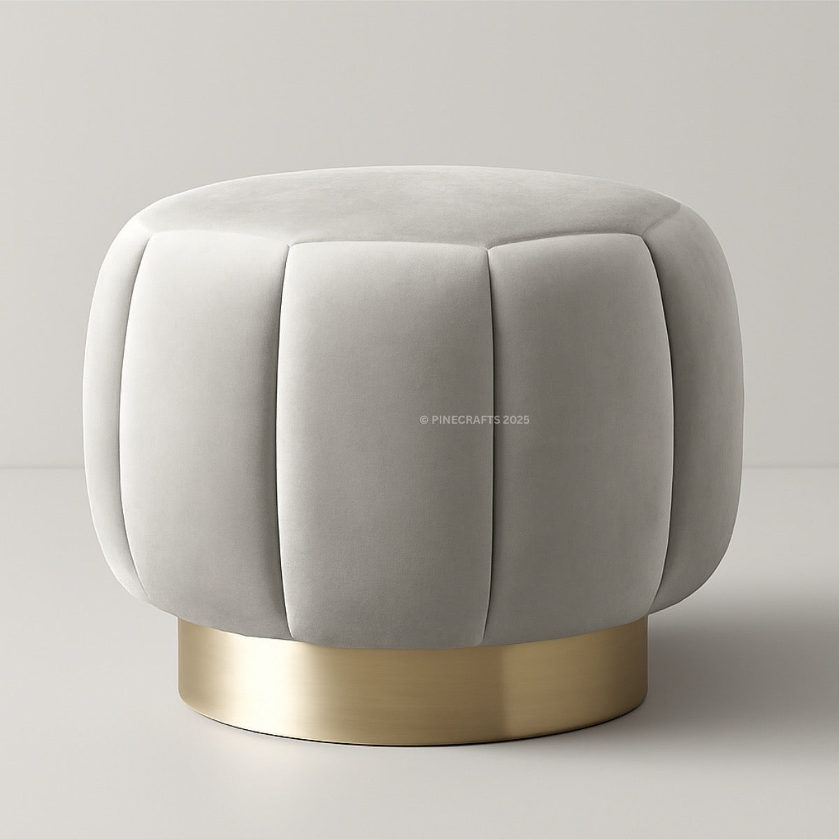 Gray upholstered stool with a gold base on a light gray background