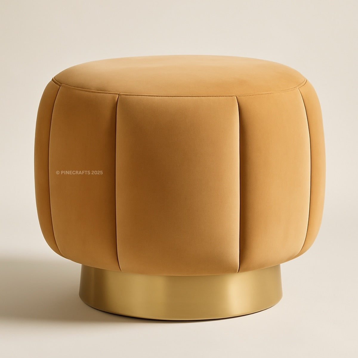Round mustard yellow ottoman with a metallic base on a beige background