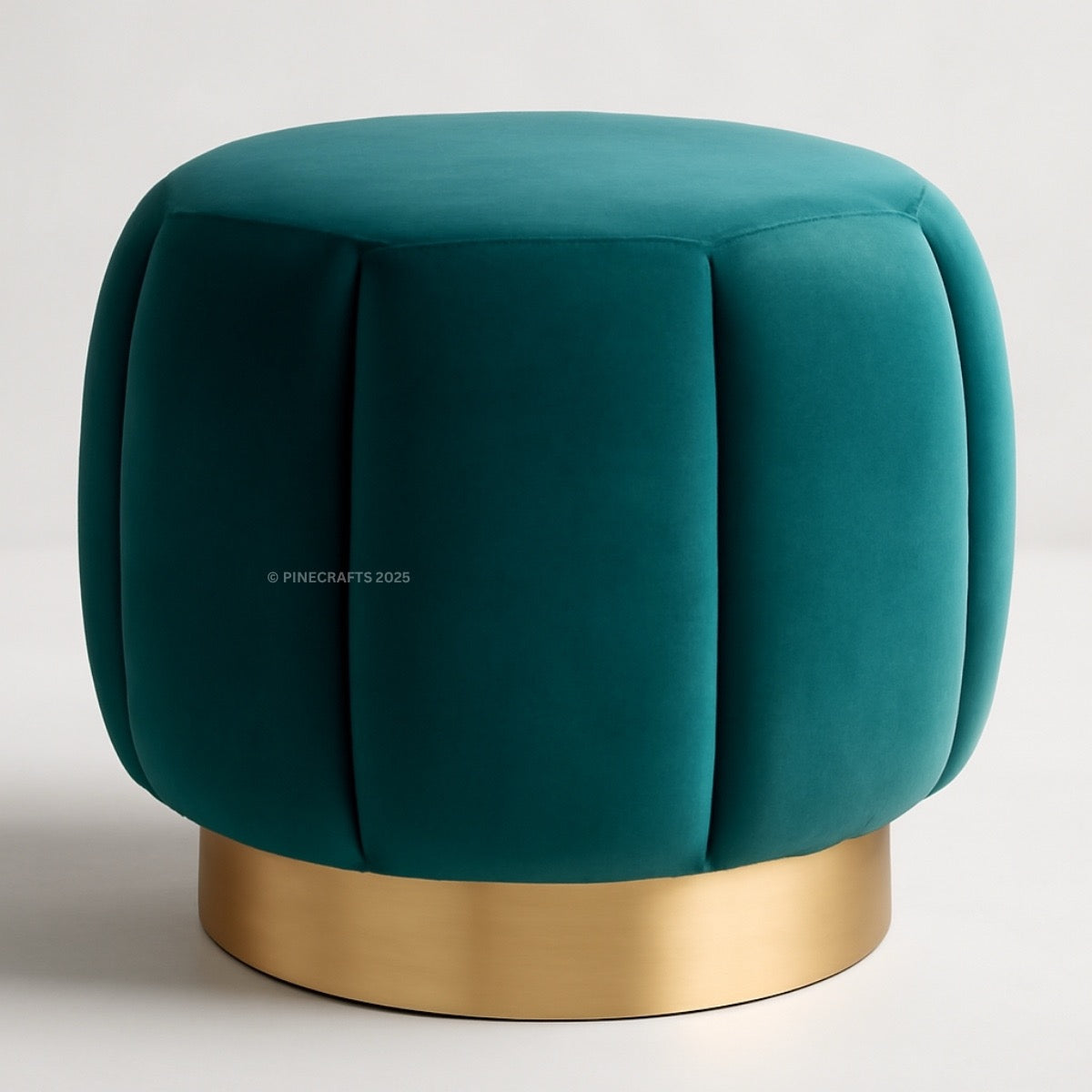 Teal velvet ottoman with a gold base on a light gray background