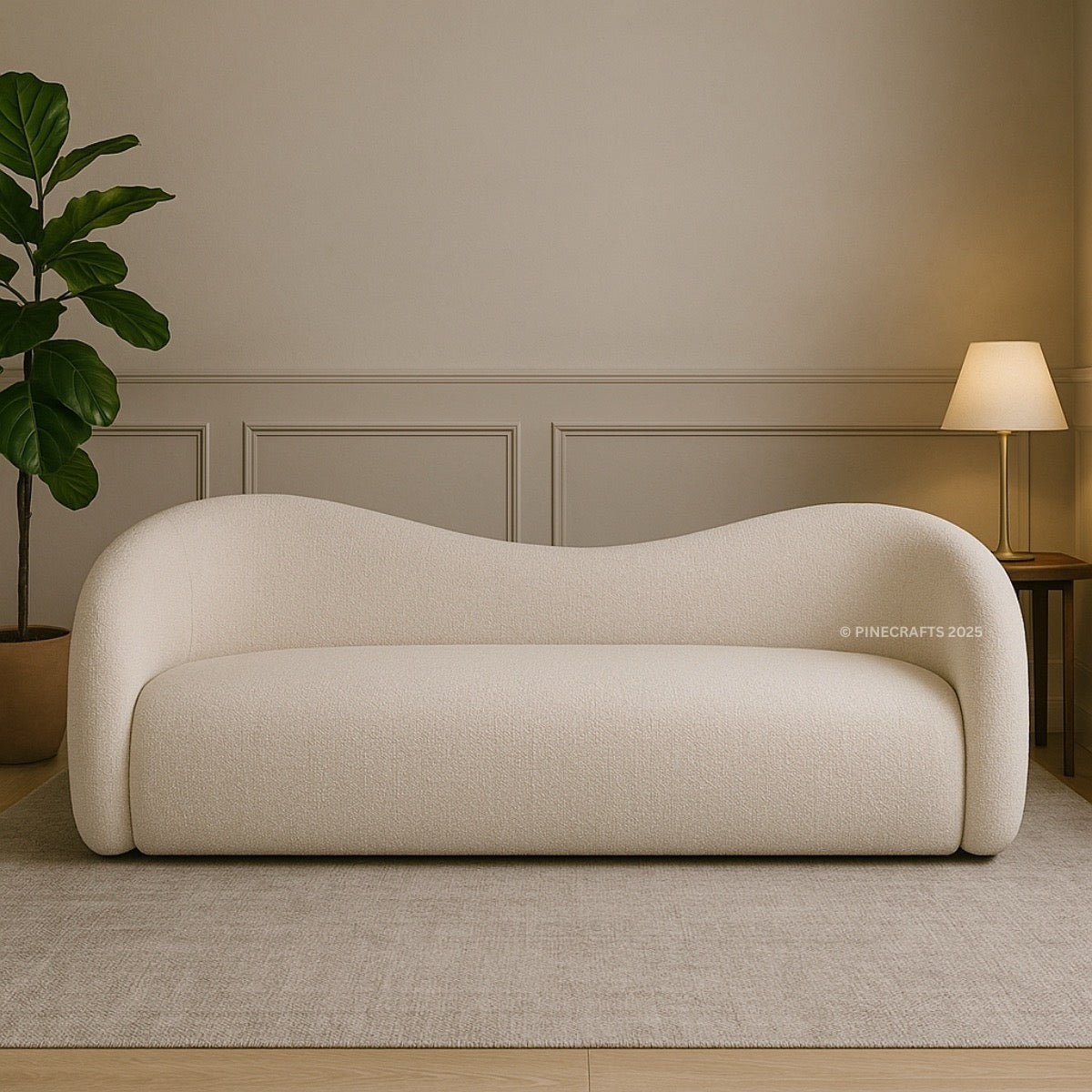 Modern beige sofa in a room with a plant and lamp.