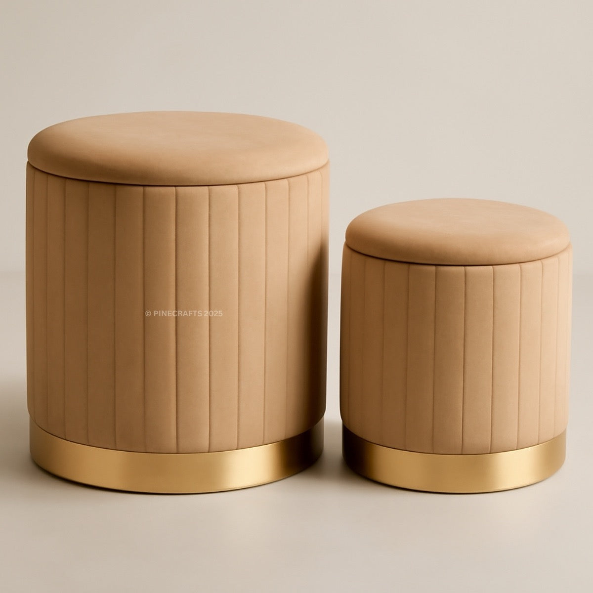 Two beige stools with gold bases on a beige background