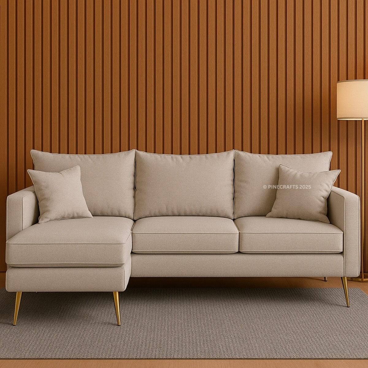 Beige sectional sofa with gold legs against a wooden paneled wall.