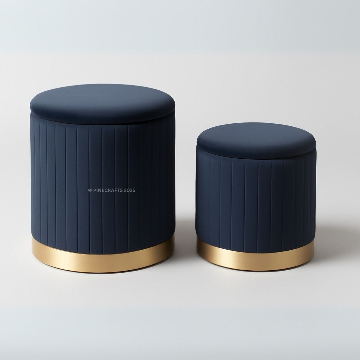 Two navy blue stools with gold bases on a light gray background