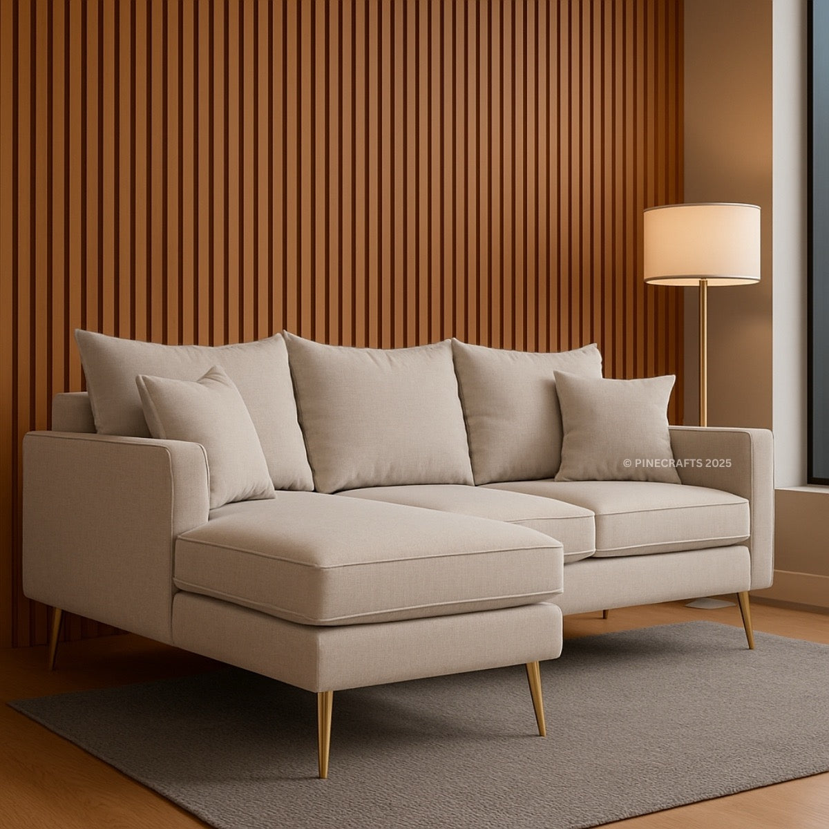 Beige sectional sofa in a living room with wooden walls and a lamp.