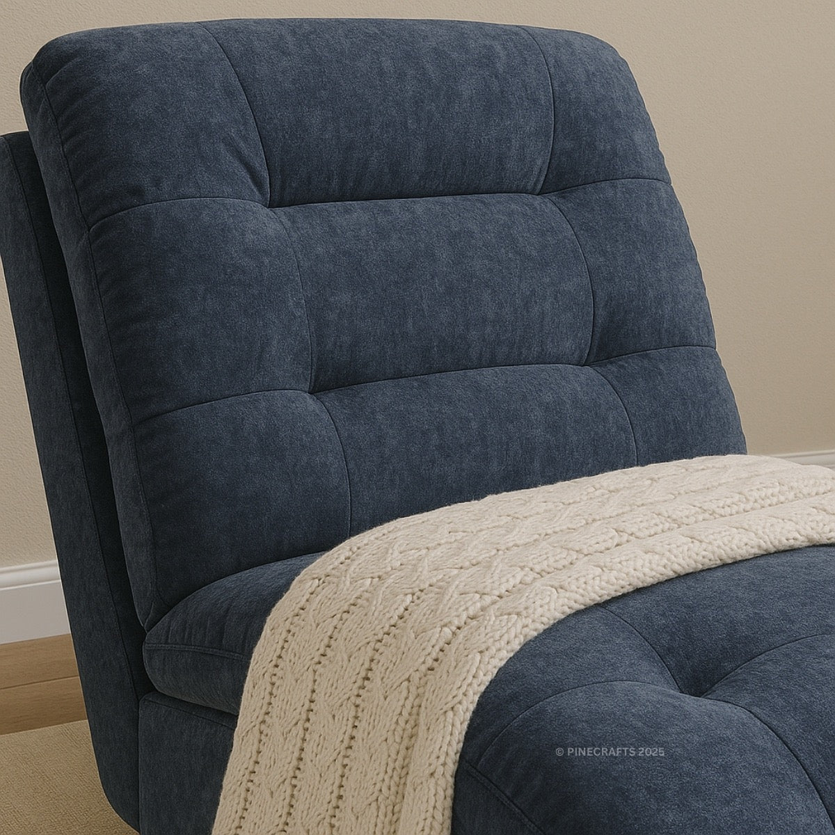 Blue upholstered chair with a beige blanket on a neutral background