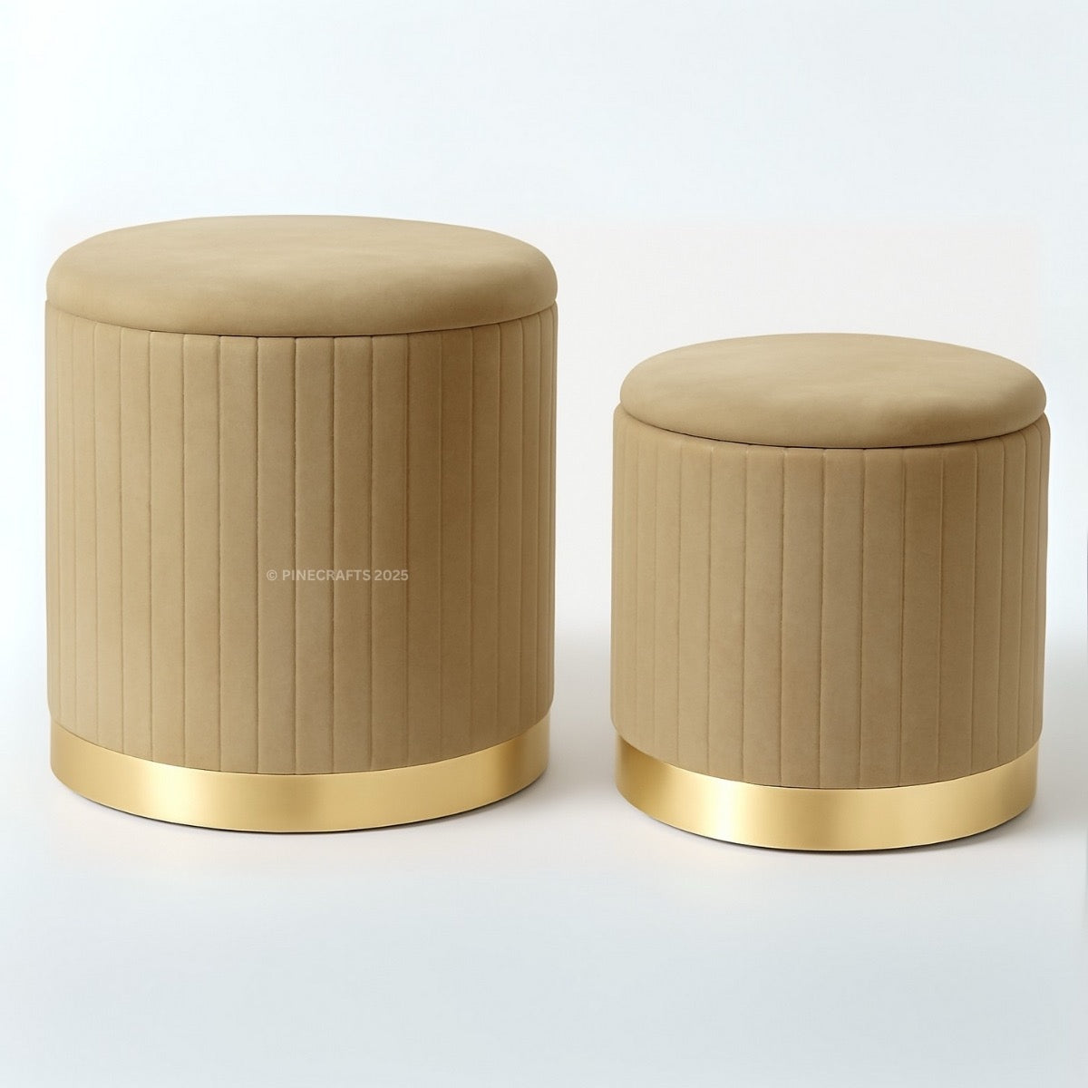 Two beige ottomans with gold bases on a white background