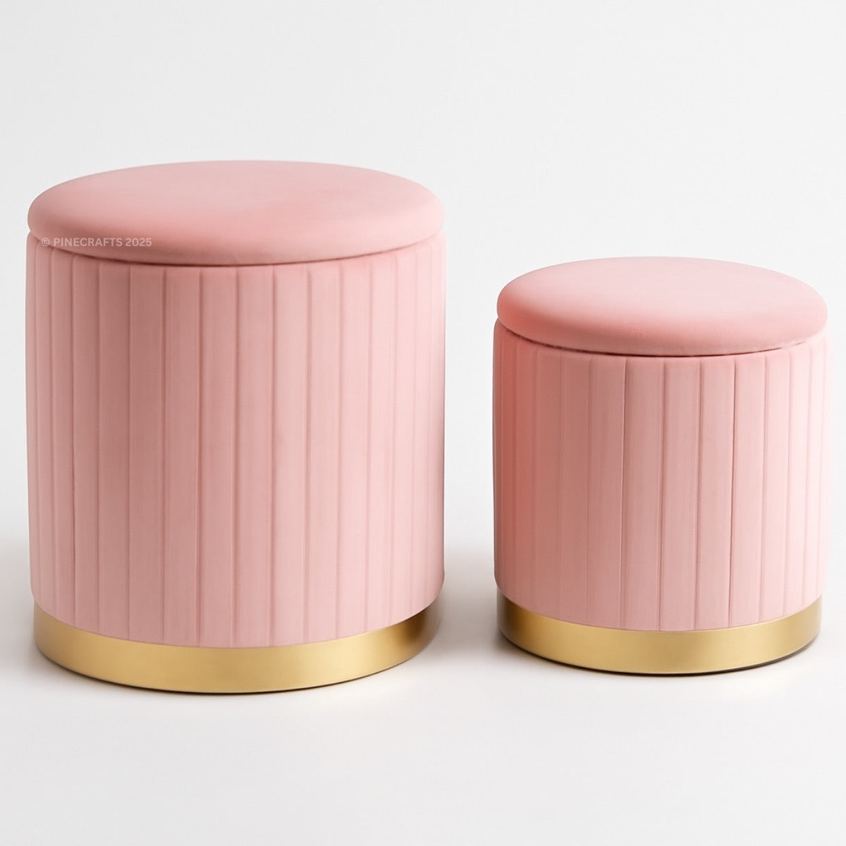 Two pink ottomans with gold bases on a white background