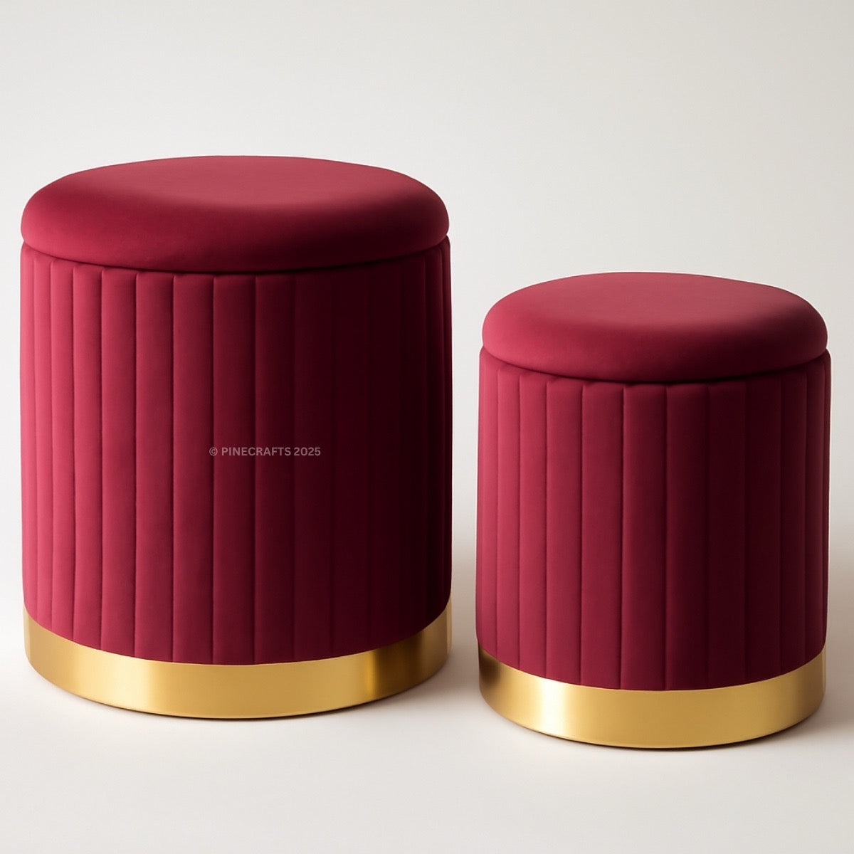 Two red stools with gold bases on a white background