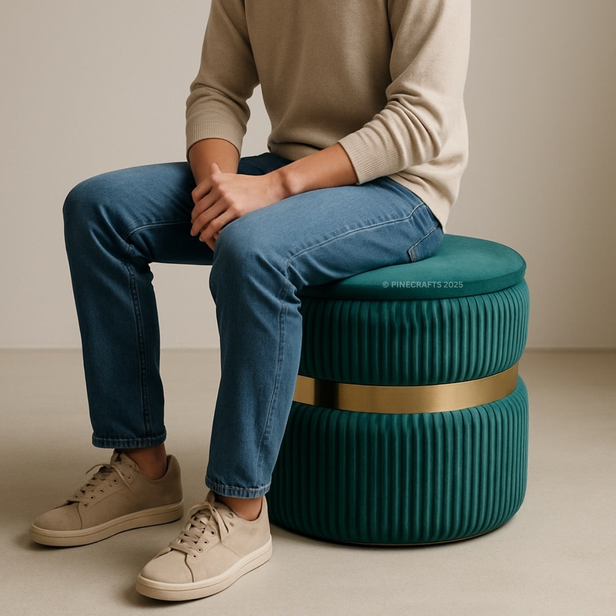 Person sitting on a teal ribbed stool with a gold band against a beige background