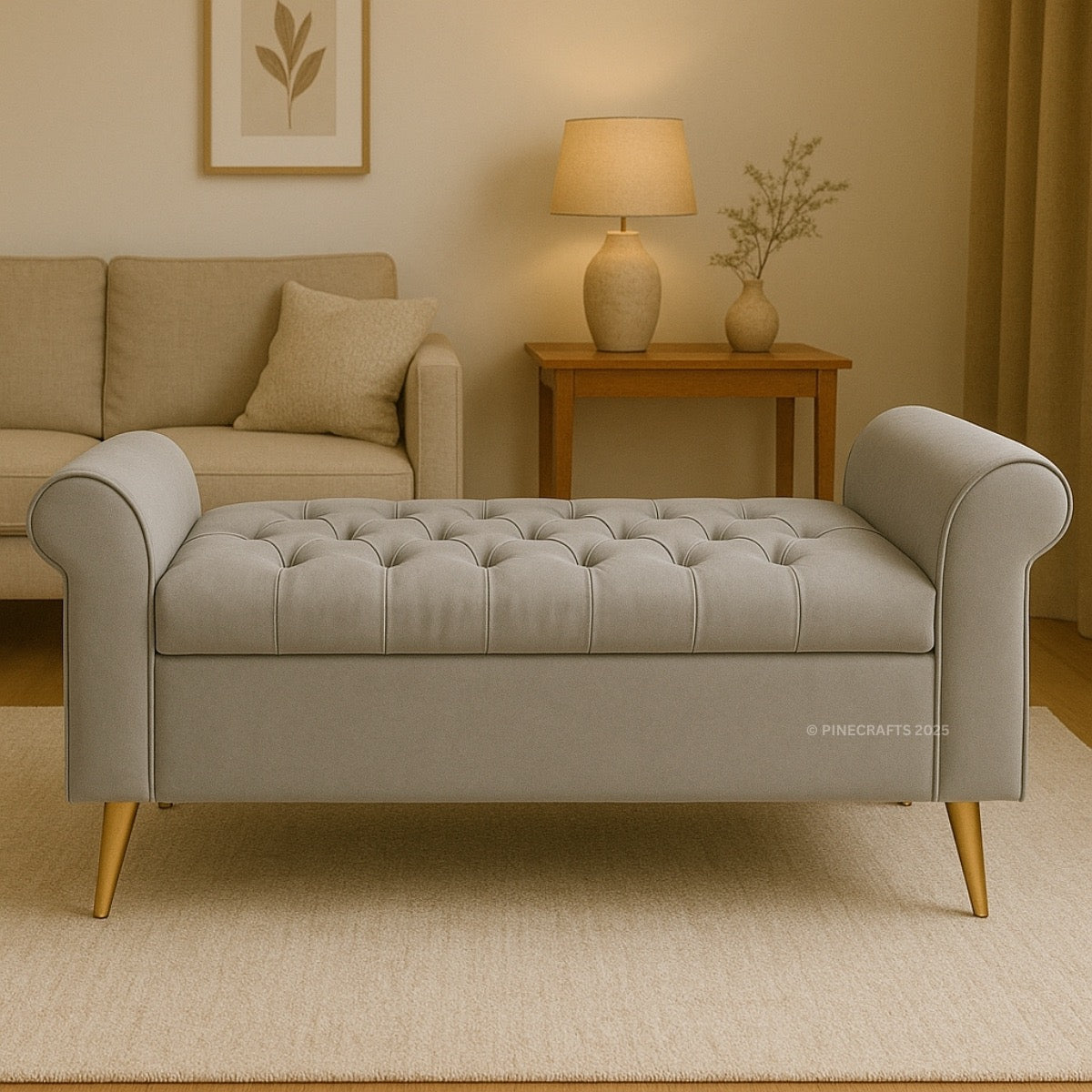 Gray tufted bench in a living room setting with a beige sofa and lamp.