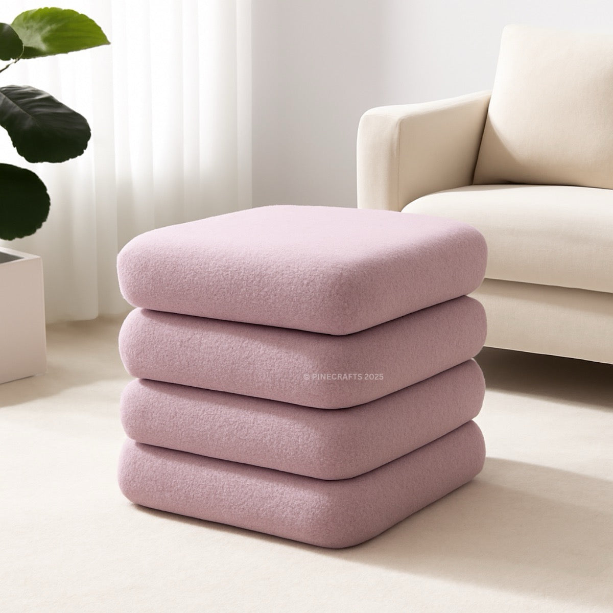 Stack of pink cushions on a light-colored floor with a neutral background