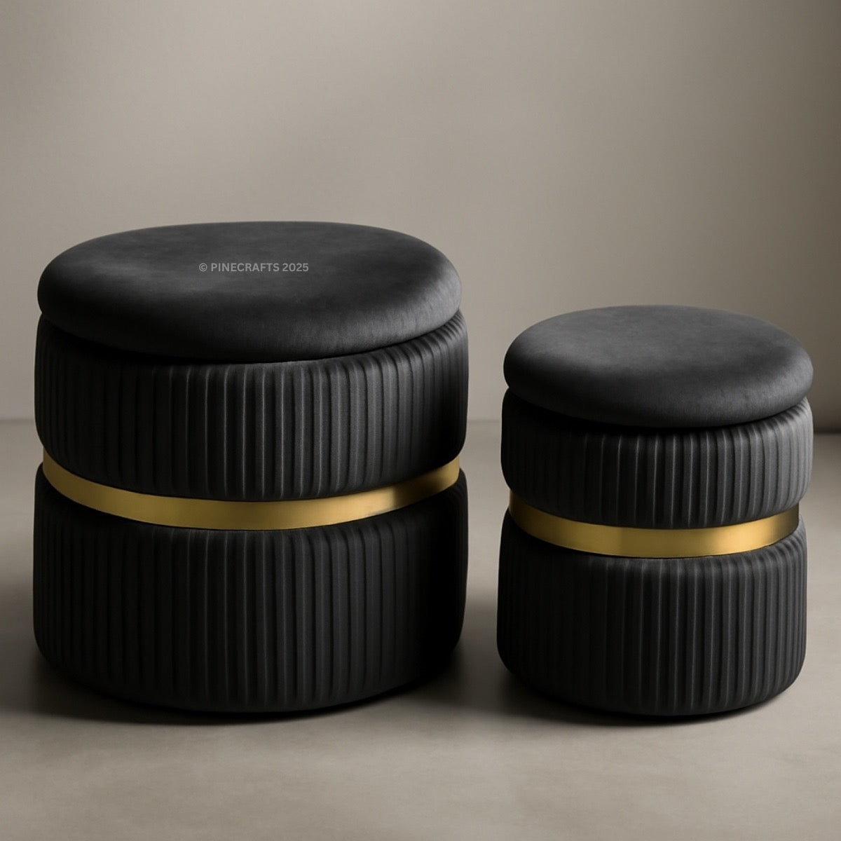 Two black cylindrical stools with ribbed texture and gold bands on a beige background