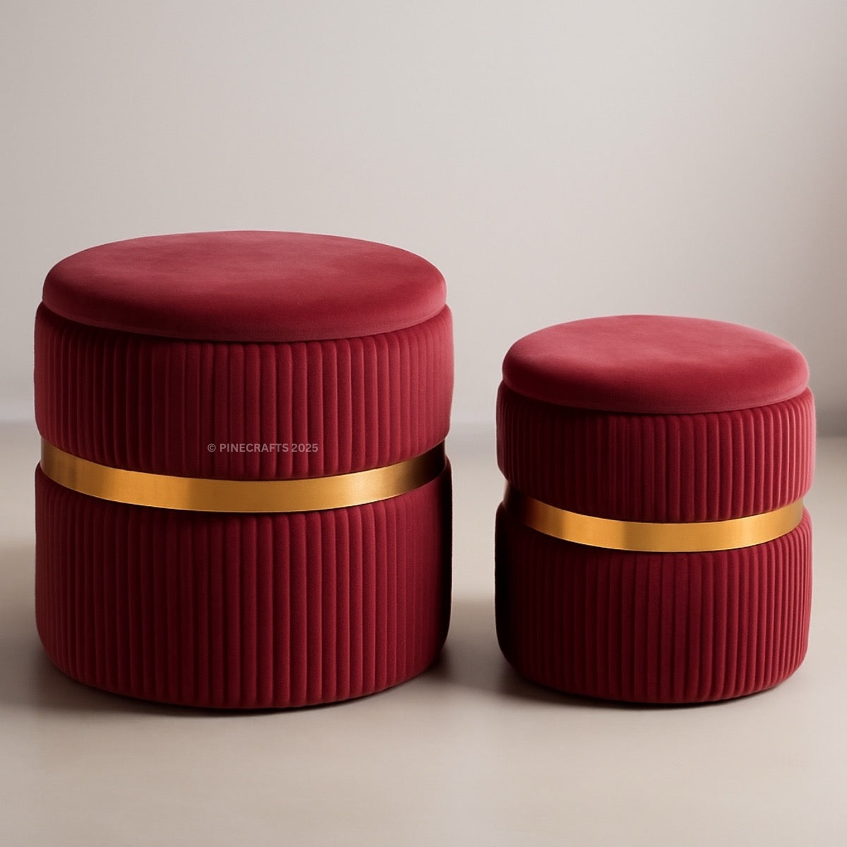 Two red ottomans with gold bands on a beige background