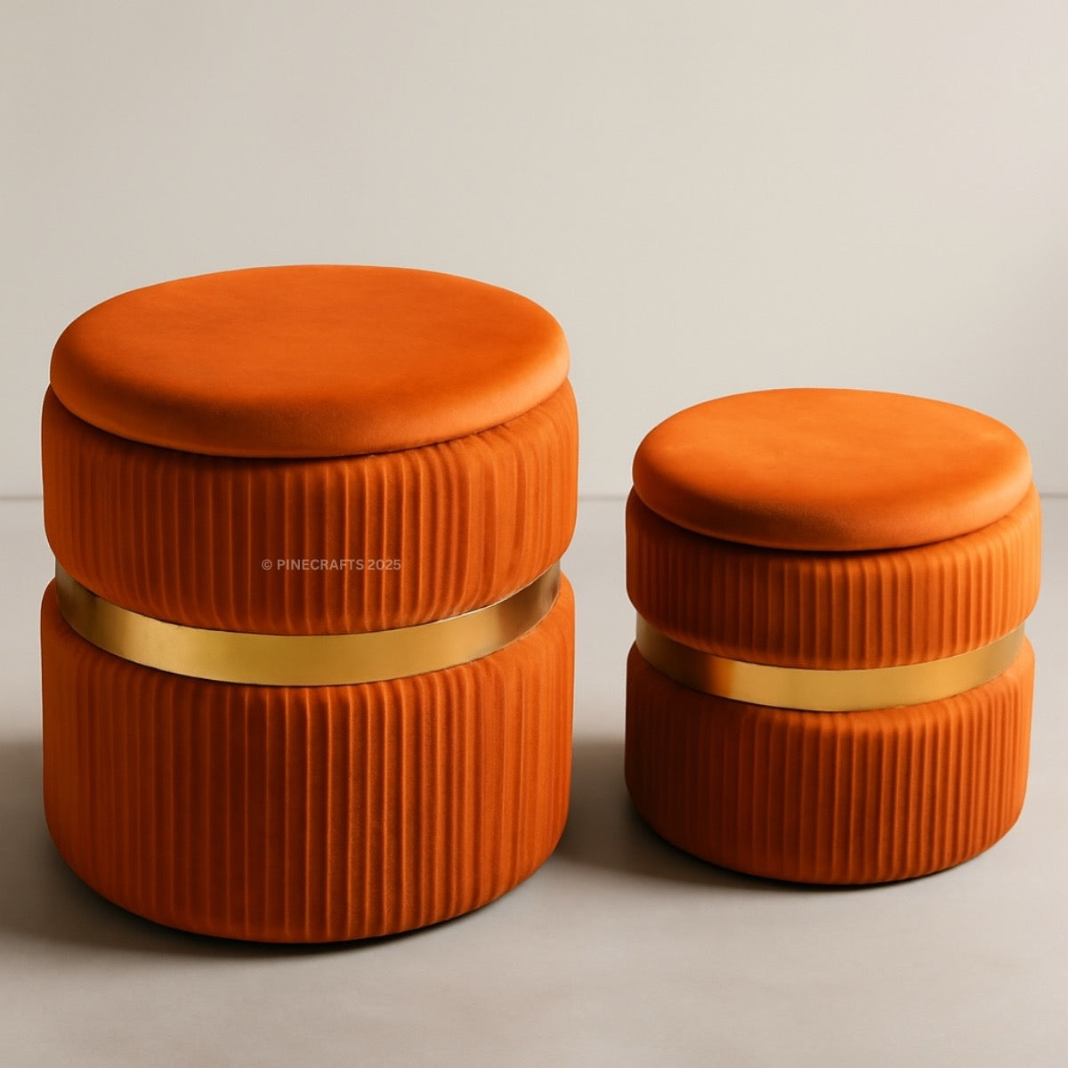 Two orange cylindrical containers with gold bands on a beige background