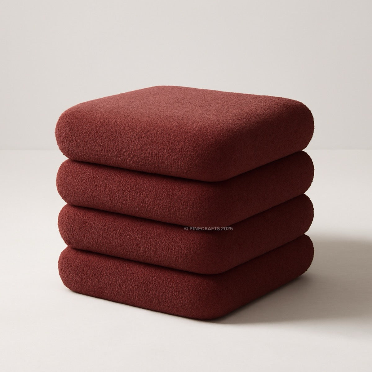 Stack of four red cushions on a light beige background