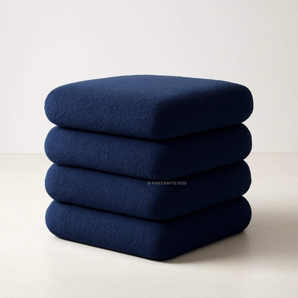 Stack of four blue cushions on a light background
