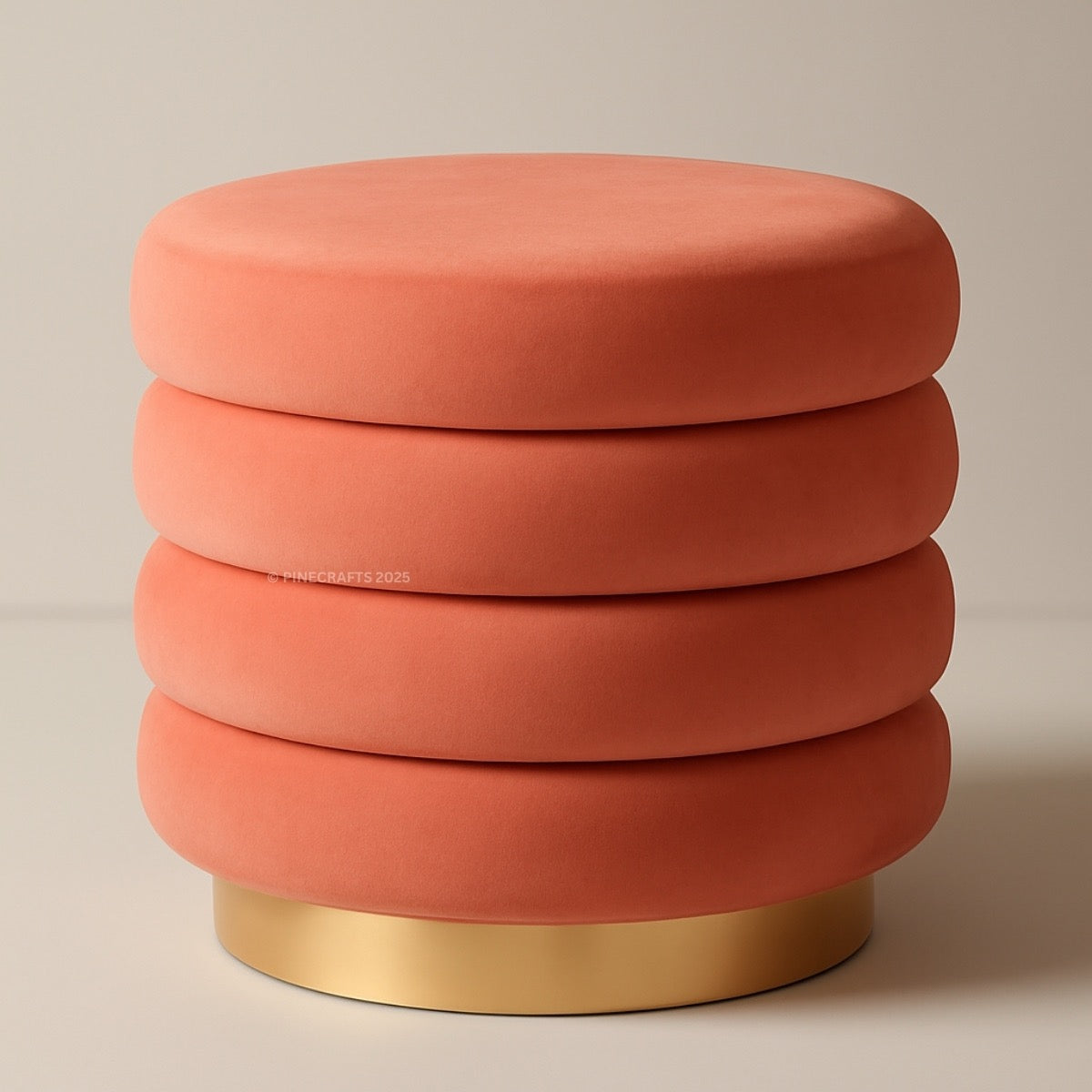 Coral-colored ottoman with a gold base on a beige background